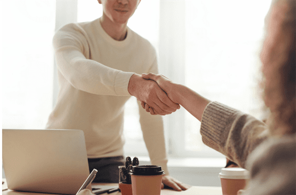 man and woman shake hands